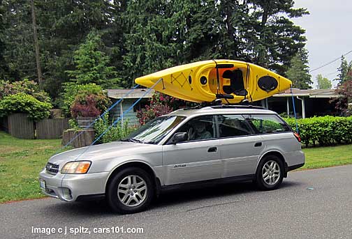 2004 silver subaru outback with 2 kayaks on the roof rack