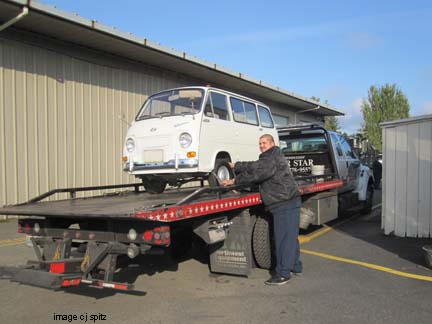the 360 Subaru van gets loaded on a flatbed to be displayed at ski show