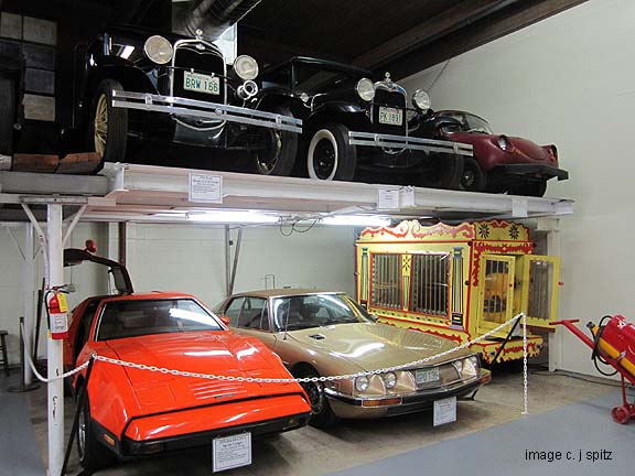 thats a 1975'safety orange' Bricklin SV1 next to a futuristic Citroen SM