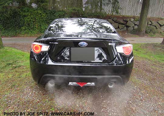 2015 Subaru BRZ Premium, rear view, with exhaust. Premiums don't come with a standard rear spoiler. Black car shown.