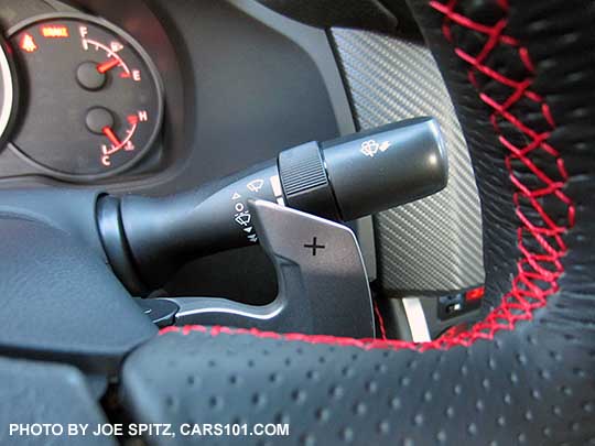 closeup of the 2016 Subaru BRZ Limited steering wheel with automatic transmission right side, up a gear Paddle Shifter. Leather wrapped wheel, red stitching.