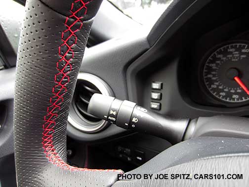 closeup of the 2016 BRZ leather wrapped steering wheel, showing the stitching pattern, red thread. Dimpled grips shown.