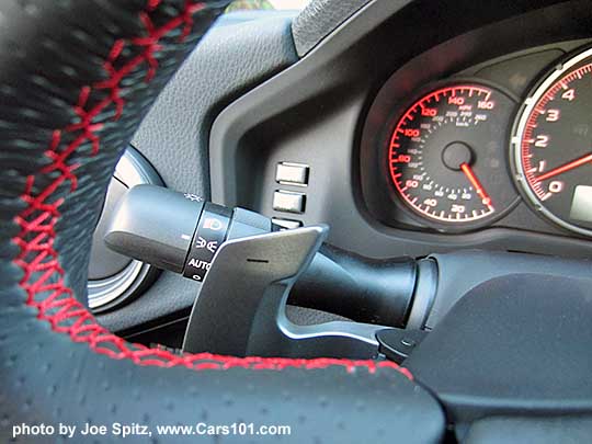 closeup of the 2016 Subaru BRZ Limited steering wheel with automatic transmission left side, down a gear Paddle Shifter. Leather wrapped wheel, red stitching.