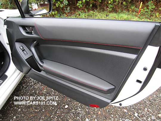 2017 Subaru BRZ Premium passenger door leatherette armrest, pebbled door insert trim, black door grip, red reflector on bottom edge (Limiteds have a courtesy light there).