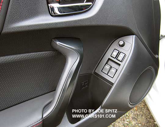 closeup of the 2017 Subaru BRZ Premium driver's door leatherette armrest, pebbled door insert trim, black door grip.
