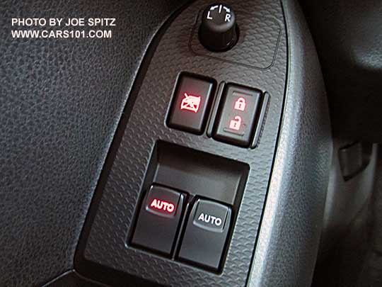 closeup of the 2017 BRZ Premium illuminated driver door power lock and driver's window switch, plastic trim plate, plastic speaker surround