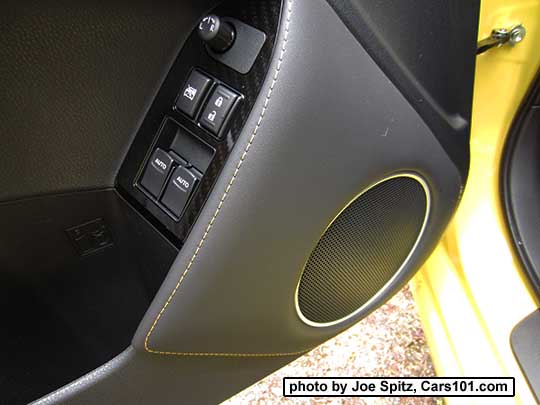 closeup of the 2017 Subaru BRZ Limited Series.Yellow driver's door panel with padded, yellow stitched door speaker trim, and gloss power window trim over carbon fiber-like under trim