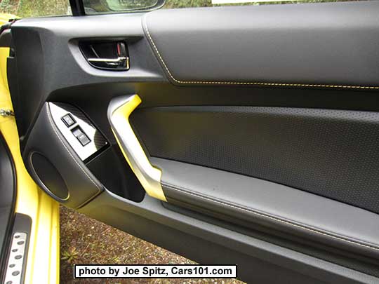 2017 Subaru BRZ Limited Series.Yellow passenger door panel with yellow door grab handle, gloss power window trim over carbon fiber-like under trim, chrome door handle, yellow stitching on the door trim and speaker trim