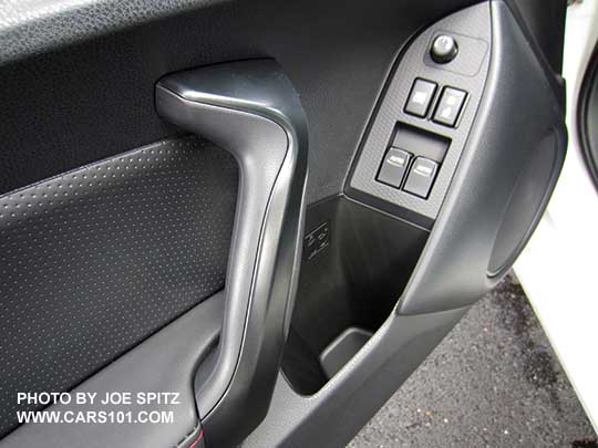 closeup of the 2017 Subaru BRZ Premium driver's door leatherette armrest, pebbled plastic door insert trim, black door grip, matte gray power window and lock trim, plastic door speaker trim