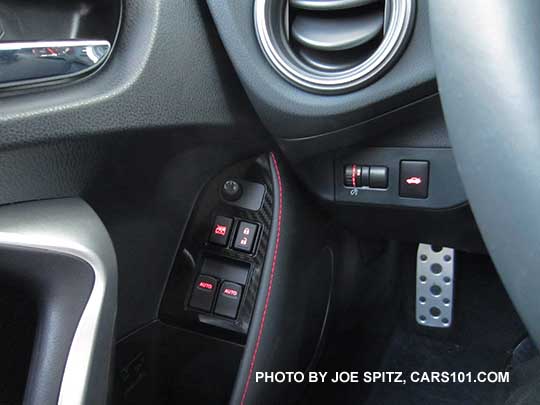 closeup of the 2017 Subaru BRZ Limited driver's door panel- silver door grip, chrome door handle, illuminated power window and door lock switches, dash rheostat, trunk opener, metal footrest