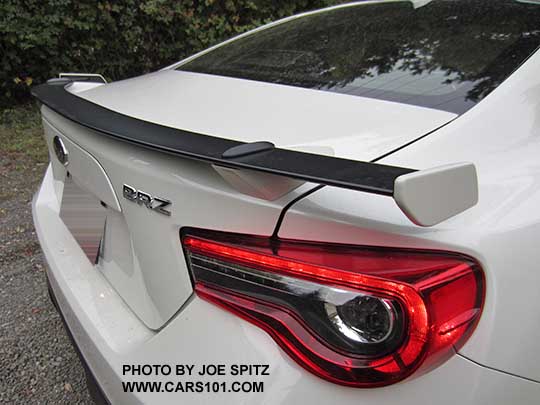 closeup of the 2017 Subaru BRZ black rear spoiler, body colored supports and tips, shown on a crystal white Limited