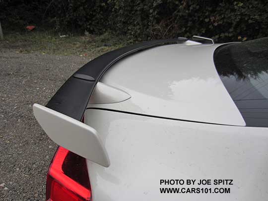 closeup of the 2017 Subaru BRZ black rear spoiler with body colored supports and tips,, shown on a crystal white Limited