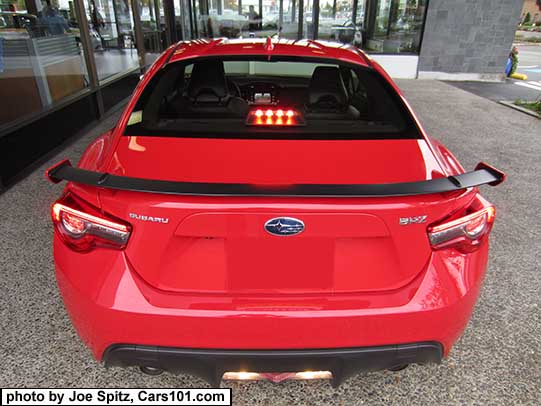 2017 BRZ black rear spoiler with body colored tips and supports. Pure red color shown. With reverse backup lights on