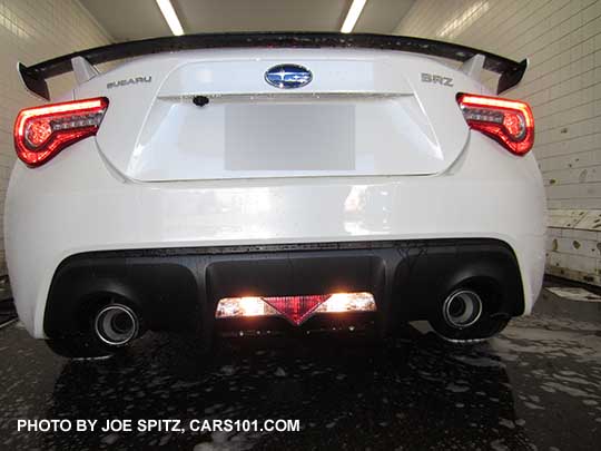 2017 Subaru BRZ in reverse showing backup lights and red triangle reflector