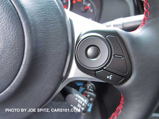 closeup of the 2017 Subaru BRZ Premium gray leather wrapped steering wheel's right side fingertip 'talk' button with blanks (on the Limited they're the performance gauge settings). Red stitching