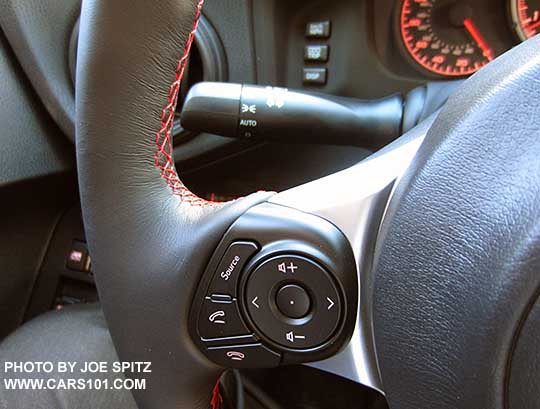 2017 Subaru BRZ Premium gray leather wrapped steering wheel left side fingertip audio and bluetooth controls, also showing the standard headlight stalk without fog lights