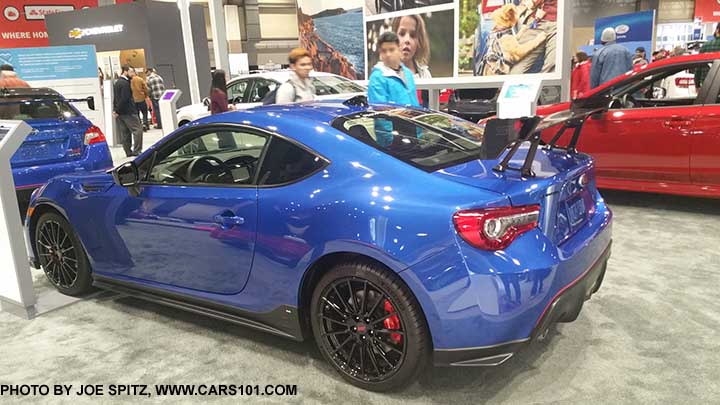 2018 Subaru BRZ tS, with adjustable STI carbon fiber rear spoiler, black STI alloys, black side rocker panel trim, rear corner underspoilers. WR Blue color shown. Seen at the 2017 Seattle Auto Show.