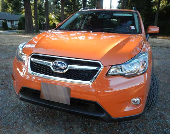 front of a tangerine orange subaru crosstrek