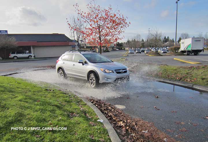 subaru crosstrek playing in a puddle