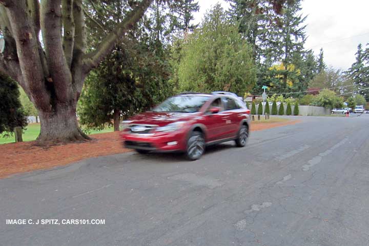 xv crosstrek in motion, venetian red