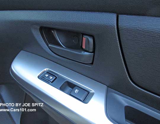 2015 Crosstrek 2.0i base model front passenger door interior panel, showing the gray interior door handle and the power window and door lock buttons without the little chrome trim
