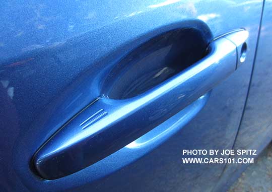 2015 Crosstrek front driver's door handle with the 2 keyless access lock hotspot strips. Drivers door with lock cylinder, quartz blue shown.