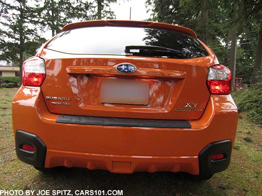 2015 Crosstrek with the optional rear bumper cover step pad, tangerine orange shown