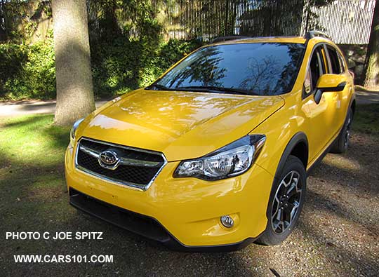 front of the 2015 Subaru Crosstrek Premium Special Edition, Sunrise Yellow color.