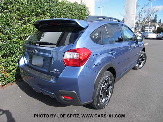 rear view 2015 Subaru Crosstrek, quartz blue color shown with optional body side moldings and rear spoiler
