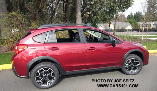 side view 2015 Crosstrek 2.0i base model with black outside mirrors, venetian red car shown,
