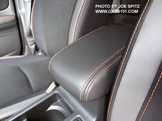 2016 Crosstrek center armrest with orange stitching. The armrest slides forward