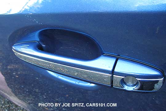 2016 Subaru Crosstrek Hybrid front door handle is body colored  with a chrome center accent strip (hybrid only). Driver's side shown with lock cylinder