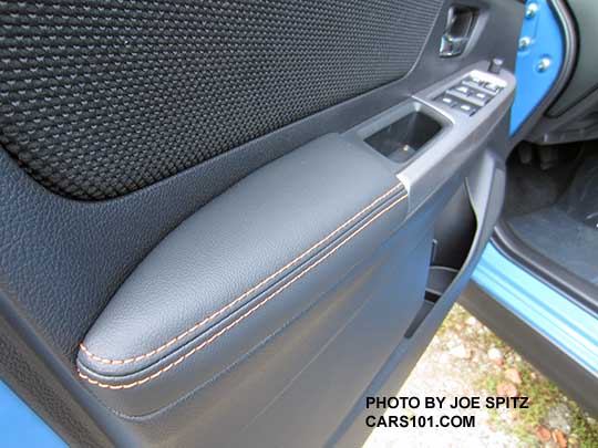 closeup of the 2016 Crosstrek inner door panel with orange stitching. Black cloth. Hyperblue exterior shown