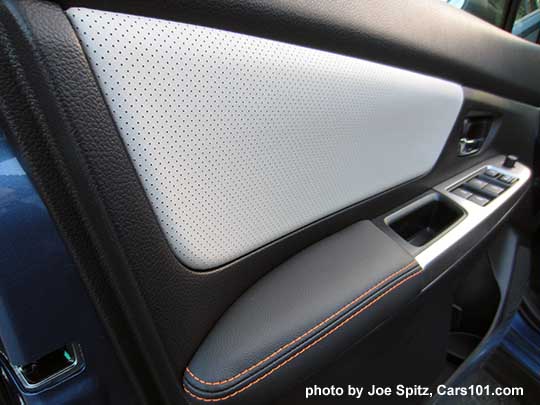 closeup of the 2016 Crosstrek driver's inner door panel. Ivory peforated leather,  orange stitching shown.