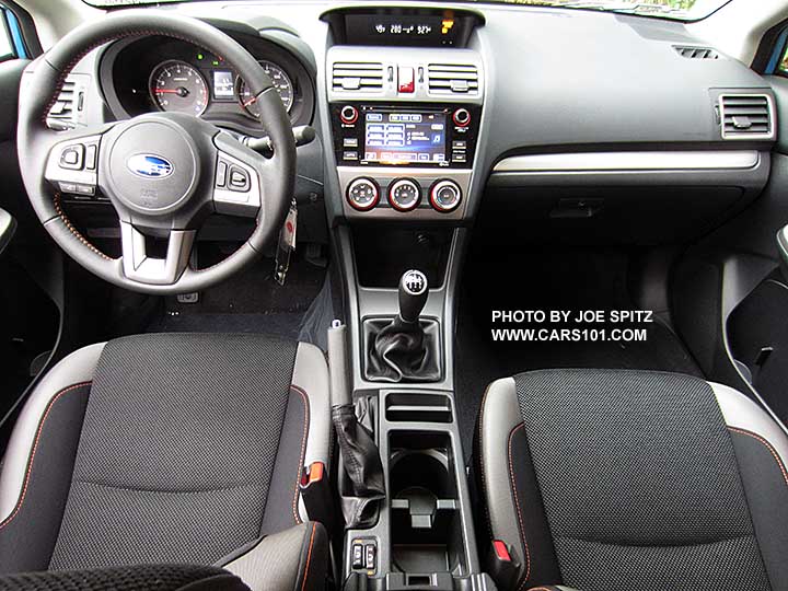 2016 Subaru Crosstrek Premium black cloth with orange stitching, silver dash trim, manual transmission shown