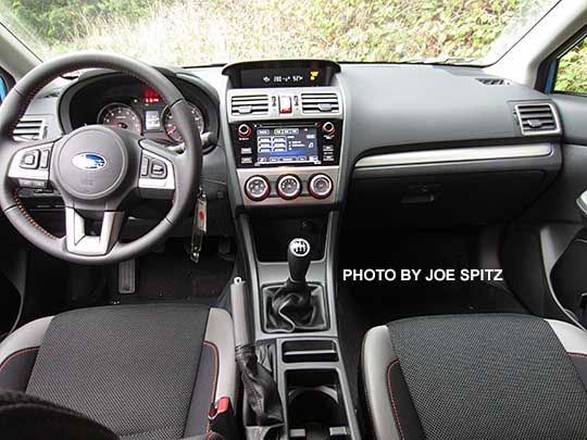 2016 Subaru Crosstrek Premium black cloth with orange stitching, silver dash trim, manual transmission shown