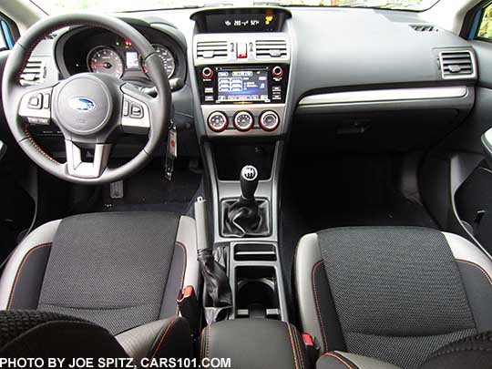2016 Subaru Crosstrek Premium black cloth with orange stitching, silver dash trim, manual transmission shown