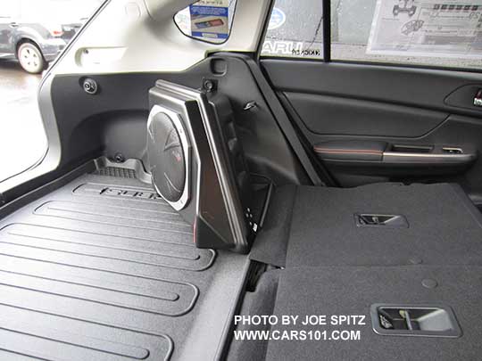 2016 Subaru Crosstrek optional Kicker subwoofer in the rear cargo area with the rear seats folded flat