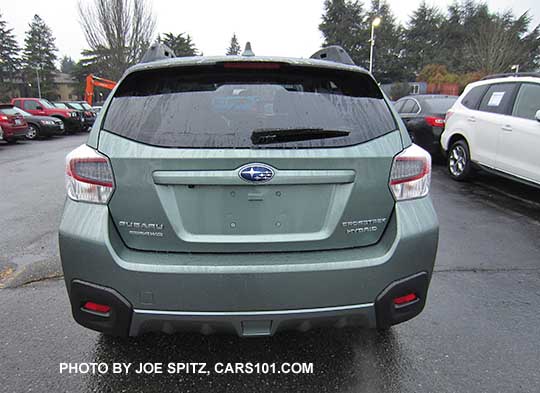 rear view Subaru Crosstrek Hybrid Touring in the rain. Jasmine Green color