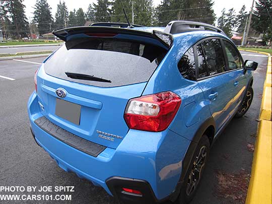 2016 Hyperblue Subaru Crosstrek with showing optional black STI rear spoiler and rear bumper cover.