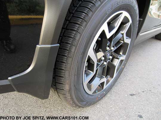 2017 and 2016 Subaru Crosstrek optional splash guard, set of four, right rear shown, on a black car