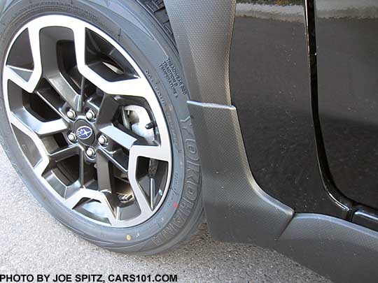 2016 Subaru Crosstrek optional splash guard, set of four, left front shown, on a black car