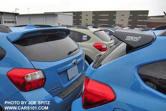 2017 and 2016 Subaru Crosstrek optional rear spoilers- body colored spoiler on left and black STI rear spoiler on the right, on hyperblue Crosstrek.