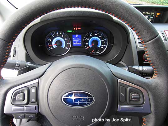 2016 Crosstrek Hybrid leather wrapped steering wheel. orange stitching. Note the blue hybrid gauges