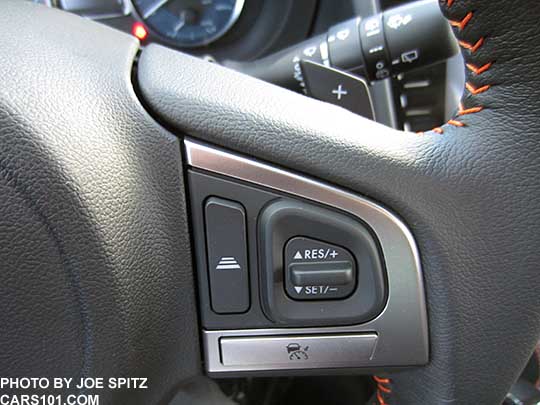 closeup of cruise control buttons with optional Eyesight on the  2016 Crosstrek leather wrapped steering wheel with orange stitching