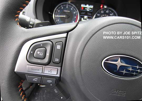 closeup of bluettoh and audio control buttons on the  2016 Crosstrek leather wrapped steering wheel with orange stitching. CVT model shown with Paddle Shifters