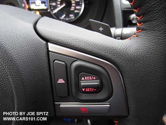 another close-up of Subaru Eyesight cruise control buttons on the  2016 Crosstrek leather wrapped steering wheel with orange stitching.  Notice the '+' Paddle Shifter