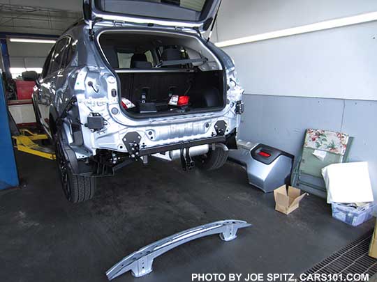 2016 Subaru Crosstrek getting an optional factory trailer hitch installed. The hitch replaces the bumper support shown on the ground