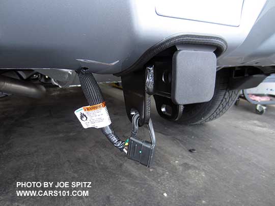 2016 Subaru Crosstrek optional 1.25" factory trailer hitch with 4 pin connector. It comes with the insert (no ball) and hitch plug. The hitch tucks up nicely into a rear bumper cut-out.