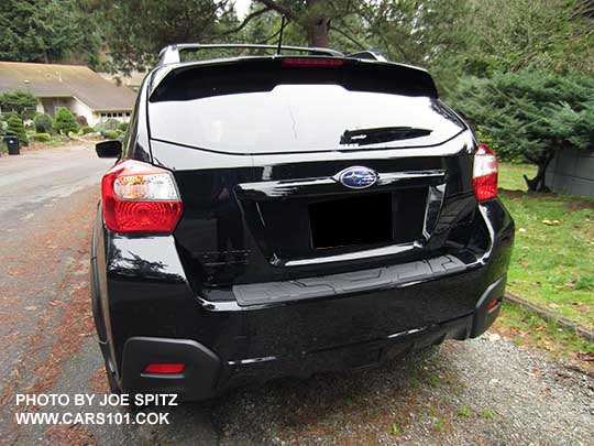 2017 Subaru Crosstrek Premium Special Edition showing rear spoiler's black rear edge and black logo. Crystal black car shown.